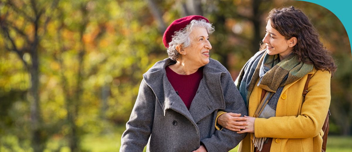 Older and younger lady walking and talking