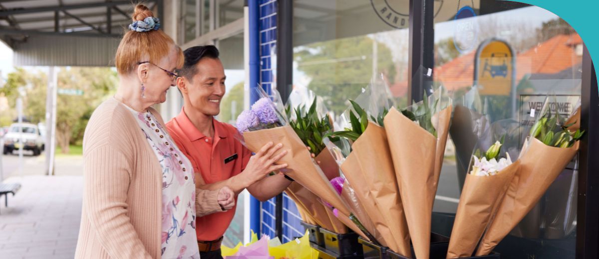 A man and woman buying flowers