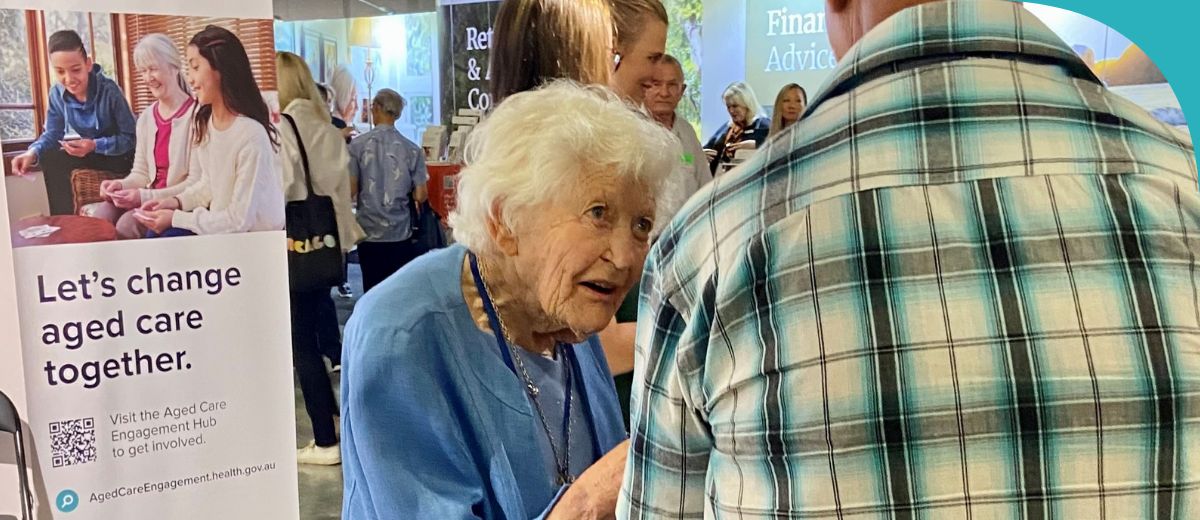 A lady talking to people at an event