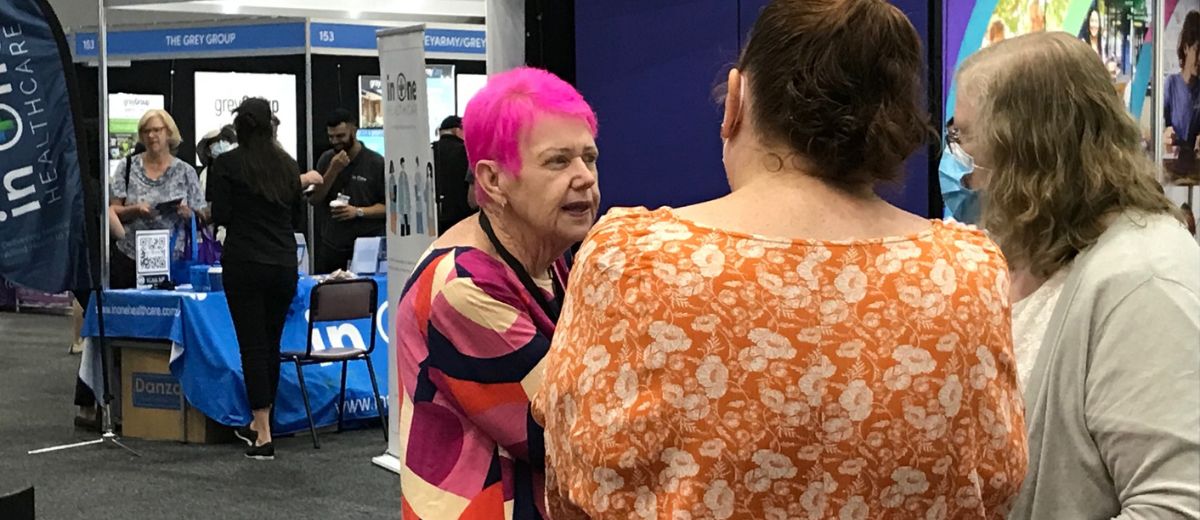 A lady talking to people at an event