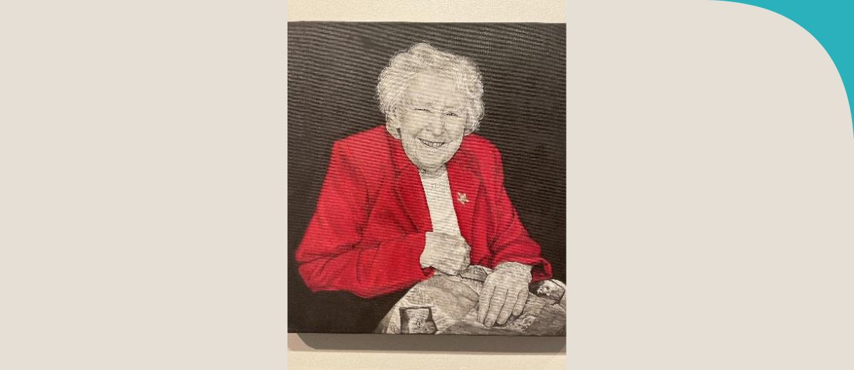 An portrait of an older lady in a red blazer